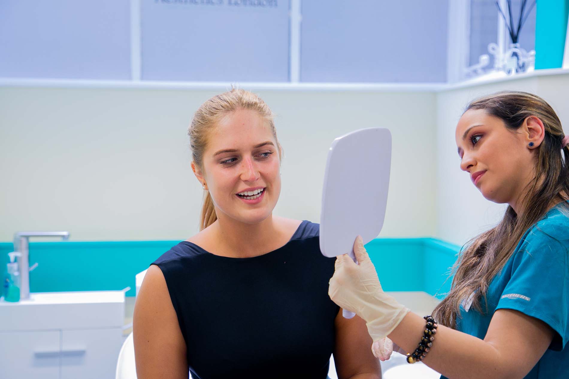 Patient reviewing her results in a mirror at JK Aesthetics London